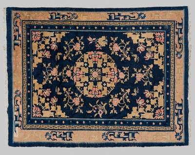 A BLUE-GROUND WOOL ‘PEONY AND LOTUS’ CARPET, QING DYNASTY