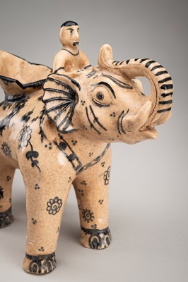 A GLAZED CERAMIC FIGURE OF AN ELEPHANT WITH RIDER