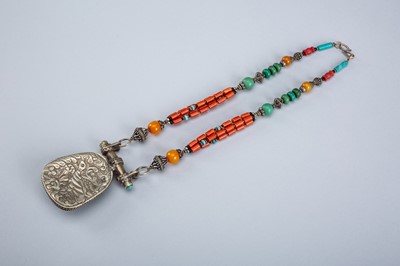 Lot 1064 - A TIBETAN NECKLACE WITH A SILVER PENDANT, c. 1920s