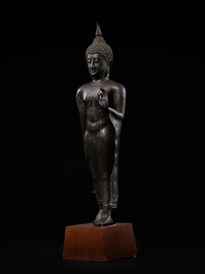 A VERY LARGE AND HIGHLY IMPORTANT BRONZE FIGURE OF A WALKING BUDDHA, SUKHOTHAI KINGDOM