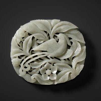 Lot 105 - A RETICULATED PALE CELADON ‘PHOENIX AND PRUNUS’ PLAQUE, YUAN TO EARLY MING DYNASTY