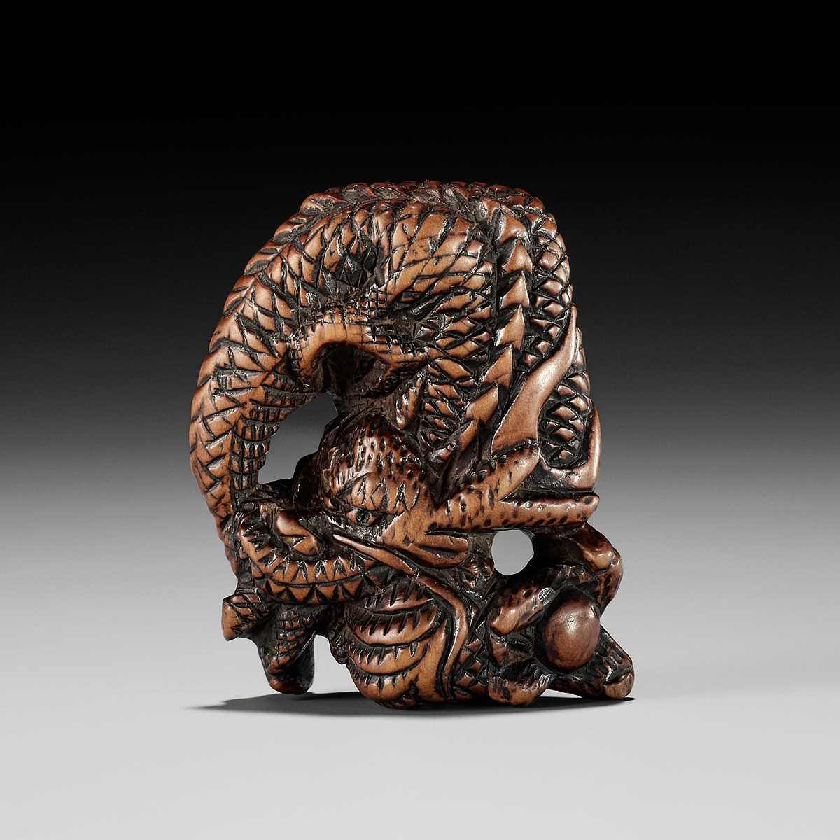 Lot 13 - A POWERFUL WOOD NETSUKE OF A COILED DRAGON