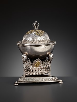 Lot 8 - A PARCEL-GILT SILVER REPOUSSÉ KAPALA WITH MATCHING COVER AND STAND, TIBET, 18TH-19TH CENTURY