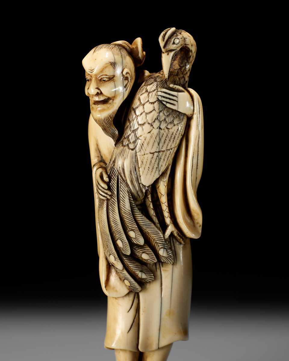 Lot 22 - A VERY RARE AND LARGE IVORY NETSUKE OF BAIFUKU WITH HO-O BIRD