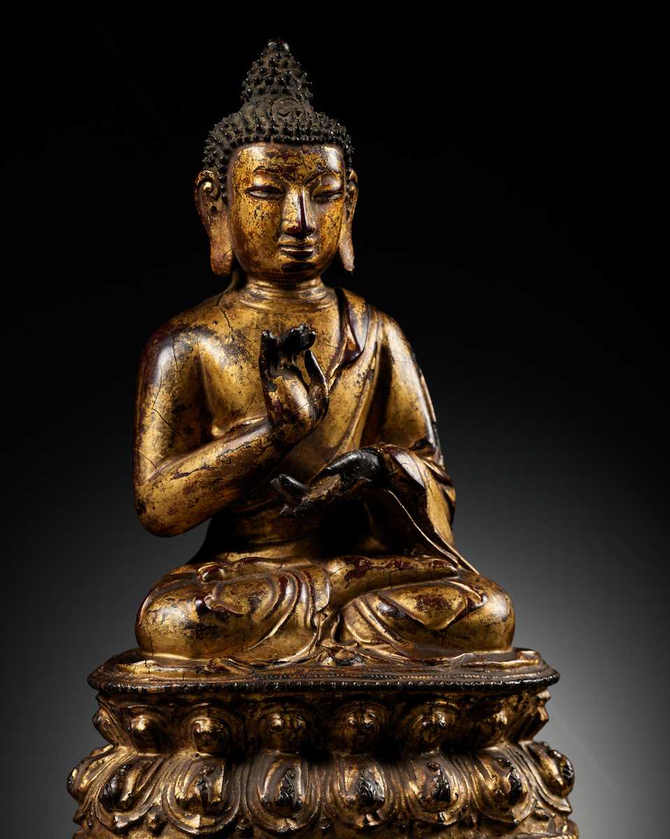Lot 51 - A RARE GILT LACQUERED BRONZE FIGURE OF BUDDHA, INSCRIBED JINGANG BUHUAI FO (BUDDHA OF ADAMANTINE INDESCTRUCTIBILITY), MING DYNASTY, 14TH-15TH CENTURY