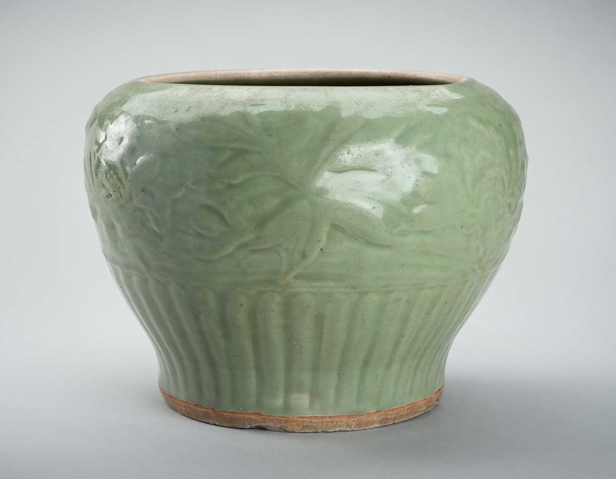 Lot 1856 - A CARVED AND MOLDED LONGQUAN CELADON ‘LOTUS’ PORCELAIN JAR, YUAN TO MING DYNASTY