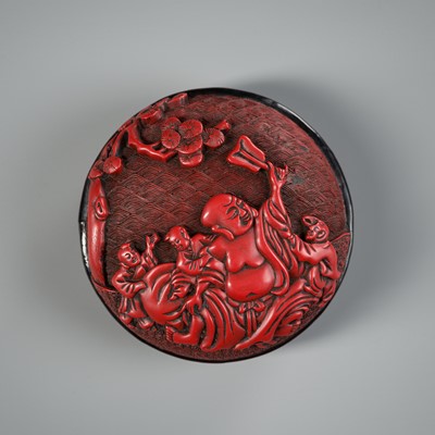 Lot 370 - A CINNABAR LACQUER ‘BUDAI AND BOYS’ BOX AND COVER, 16TH-17TH CENTURY