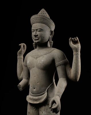 Lot 185 - A RARE AND LARGE FOUR-ARMED SANDSTONE FIGURE OF VISHNU, ANGKOR PERIOD