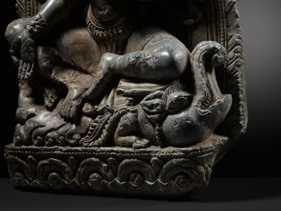 A BLACK STONE STELE OF VARUNI, THE GODDESS OF WINE, NEPAL, 13TH CENTURY