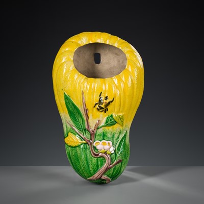 AN ENAMELED BISCUIT PORCELAIN ‘MELON AND BEE’ WALL VASE, QING DYNASTY