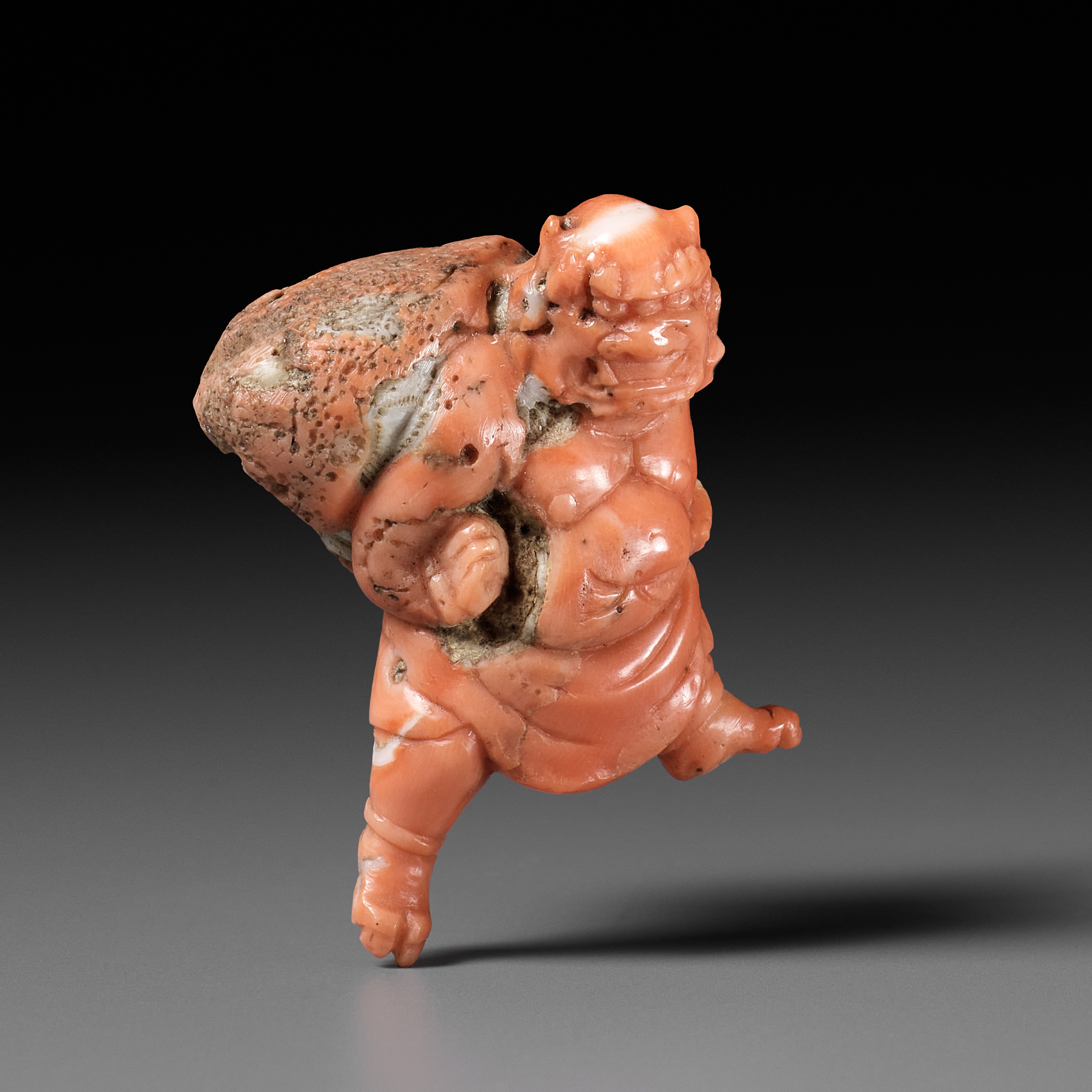 Lot 304 - A VERY RARE SOLID CORAL NETSUKE OF FUJIN