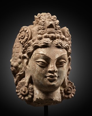 Lot 232 - A LARGE STUCCO HEAD OF A BODHISATTVA, ANCIENT REGION OF GANDHARA, 4TH-5TH CENTURY