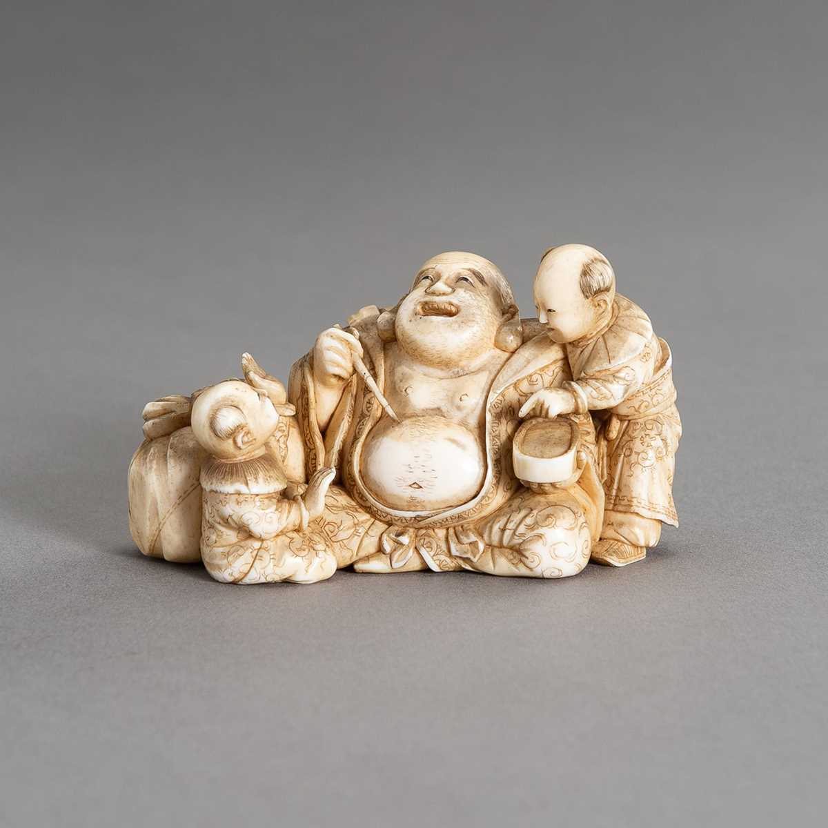 Lot 315 - CHIKAHIDE: AN IVORY OKIMONO OF HOTEI WITH TWO KARAKO
