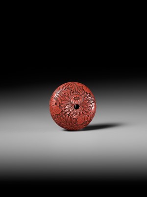A FINE TSUISHU (CARVED RED LACQUER) MANJU NETSUKE WITH CHRYSANTHEMUMS