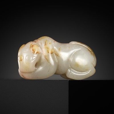 Lot 442 - A PALE GREY AND RUSSET JADE FIGURE OF A TIGER, MING DYNASTY