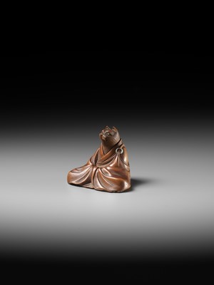 Lot 59 - ANRAKU: A FINE AND HUMOROUS WOOD NETSUKE OF TANUKI DISGUISED AS A PRIEST