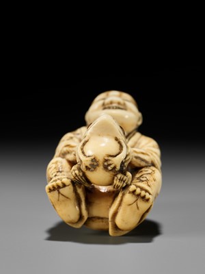 Lot 71 - MASATSUGU: AN AMUSING OSAKA SCHOOL IVORY NETSUKE OF GAMA SENNIN LIFTING HIS TOAD