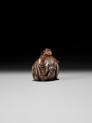 AN OLD WOOD NETSUKE OF A CHINESE SCHOLAR