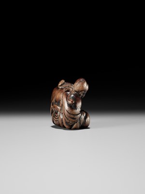 AN OLD WOOD NETSUKE OF A CHINESE SCHOLAR