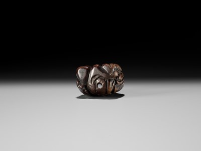 AN OLD WOOD NETSUKE OF A CHINESE SCHOLAR