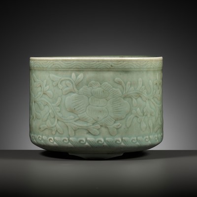 Lot 228 - A CARVED CELADON GLAZED ‘PEONY’ BRUSHPOT, BITONG, KANGXI PERIOD