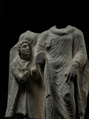 Lot 336 - A LARGE GRAY SCHIST RELIEF DEPICTING BUDDHA AND A ROYAL DONOR, ANCIENT REGION OF GANDHARA