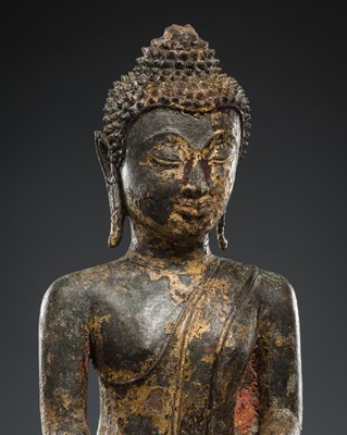 Lot 590 - A GILT BRONZE FIGURE OF BUDDHA SHAKYAMUNI, LAOS, 16TH-17TH CENTURY