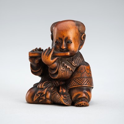 Lot 608 - SUKEKAZU: A WOOD NETSUKE OF A KARAKO PLAYING THE FLUTE