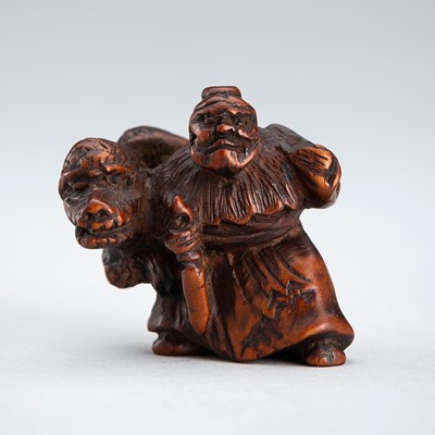 A SIGNED WOOD NETSUKE OF BASHIKO SENNIN