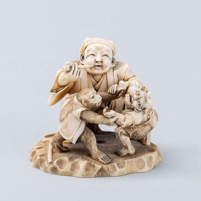 Lot 705 - A SIGNED IVORY NETSUKE-OKIMONO OF A SARUMAWASHI (MONKEY TRAINER) WITH MONKEY AND ONI