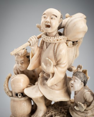 Lot 712 - A MARINE IVORY OKIMONO OF TAKOTSUBO AND FISHERMEN