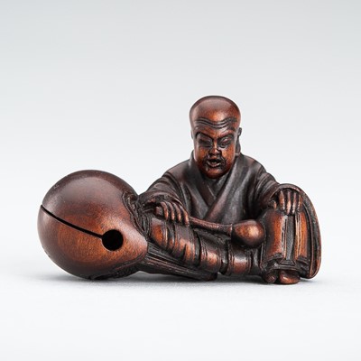 Lot 597 - SHURAKU: A FINE WOOD NETSUKE OF A MONK WITH MOKUGYO