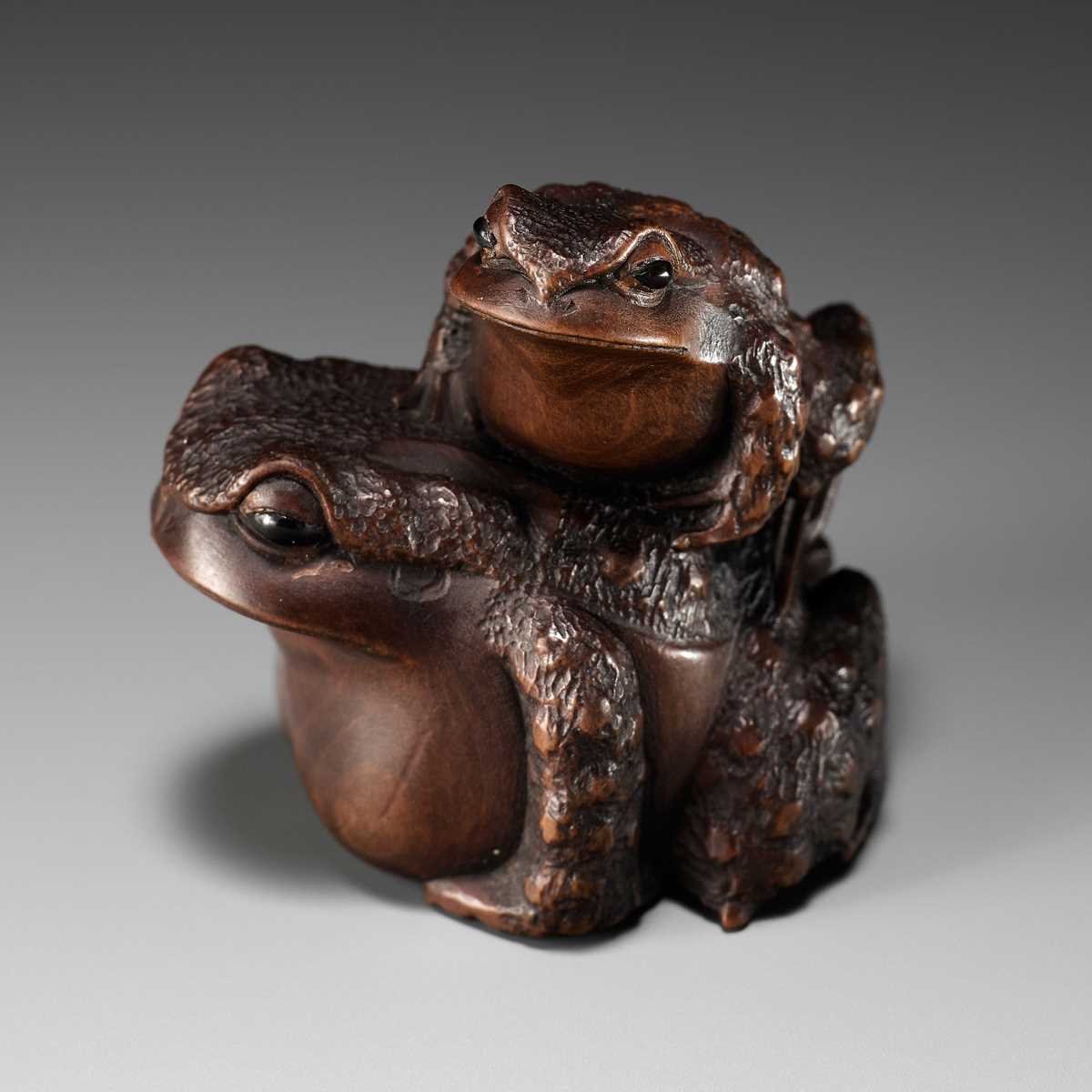 Lot 84 - MASANAO: A FINE WOOD NETSUKE OF A TOAD WITH YOUNG