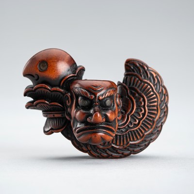 Lot 494 - A BOXWOOD NETSUKE OF A BUGAKU HELMET (TORIKABUTO)