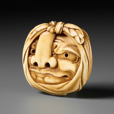 Lot 505 - HOICHI: AN IVORY MASK NETSUKE OF A KONOHA TENGU MASK WRAPPED IN FUROSHIKI