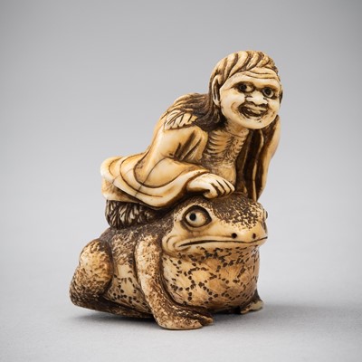 Lot 451 - AN IVORY NETSUKE OF GAMA SENNIN SITTING ON A TOAD