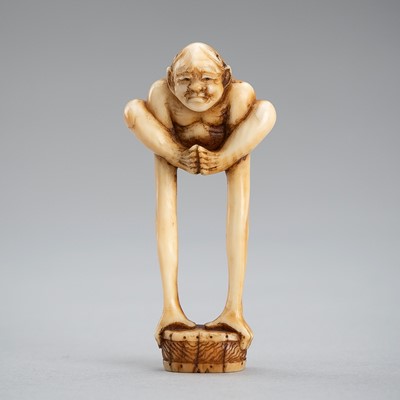 Lot 602 - MINKOKU: A MARINE IVORY NETSUKE OF TENAGA AS AN ACROBAT