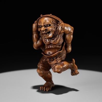 Lot 604 - A BOXWOOD NETSUKE OF AN ONI AT SETSUBUN