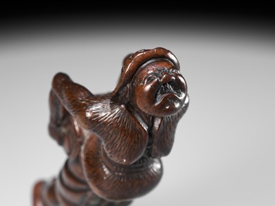 Lot 24 - A LARGE WOOD NETSUKE OF A DUTCHMAN WITH A DRUM