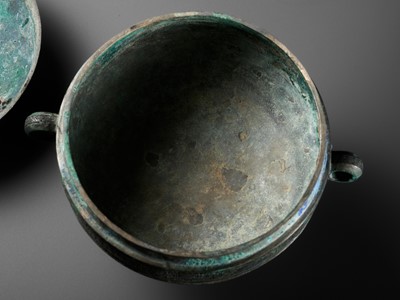 Lot 64 - AN ARCHAIC BRONZE RITUAL FOOD VESSEL AND COVER, DOU, WITH ELEVEN BANDS OF DECORATION, LATE SPRING AND AUTUMN TO EARLY WARRING STATES PERIOD