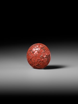 Lot 288 - A FINE TSUISHU (CARVED RED LACQUER) MANJU NETSUKE WITH PEACH BLOSSOMS