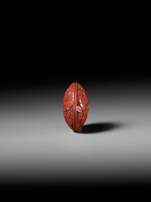 Lot 288 - A FINE TSUISHU (CARVED RED LACQUER) MANJU NETSUKE WITH PEACH BLOSSOMS