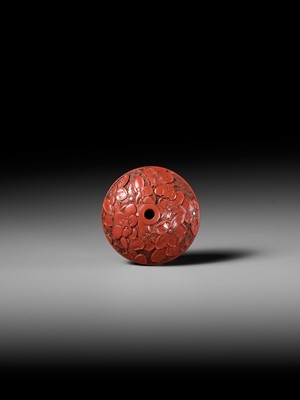 Lot 288 - A FINE TSUISHU (CARVED RED LACQUER) MANJU NETSUKE WITH PEACH BLOSSOMS