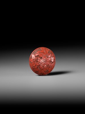 Lot 288 - A FINE TSUISHU (CARVED RED LACQUER) MANJU NETSUKE WITH PEACH BLOSSOMS
