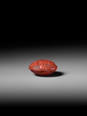 Lot 288 - A FINE TSUISHU (CARVED RED LACQUER) MANJU NETSUKE WITH PEACH BLOSSOMS