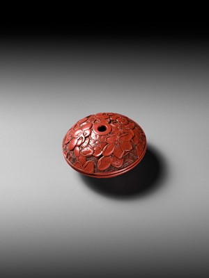 Lot 288 - A FINE TSUISHU (CARVED RED LACQUER) MANJU NETSUKE WITH PEACH BLOSSOMS