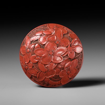 Lot 288 - A FINE TSUISHU (CARVED RED LACQUER) MANJU NETSUKE WITH PEACH BLOSSOMS