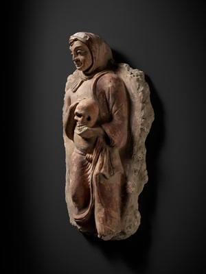 Lot 338 - A RARE POLYCHROME STUCCO RELIEF DEPICTING A MONK WITH A SKULL, ANCIENT REGION OF GANDHARA