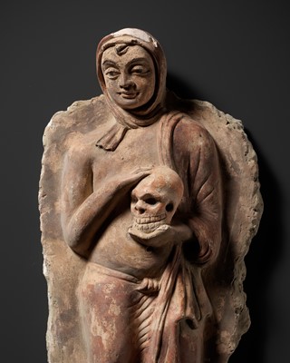 A RARE POLYCHROME STUCCO RELIEF DEPICTING A MONK WITH A SKULL, ANCIENT REGION OF GANDHARA