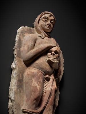 Lot 338 - A RARE POLYCHROME STUCCO RELIEF DEPICTING A MONK WITH A SKULL, ANCIENT REGION OF GANDHARA